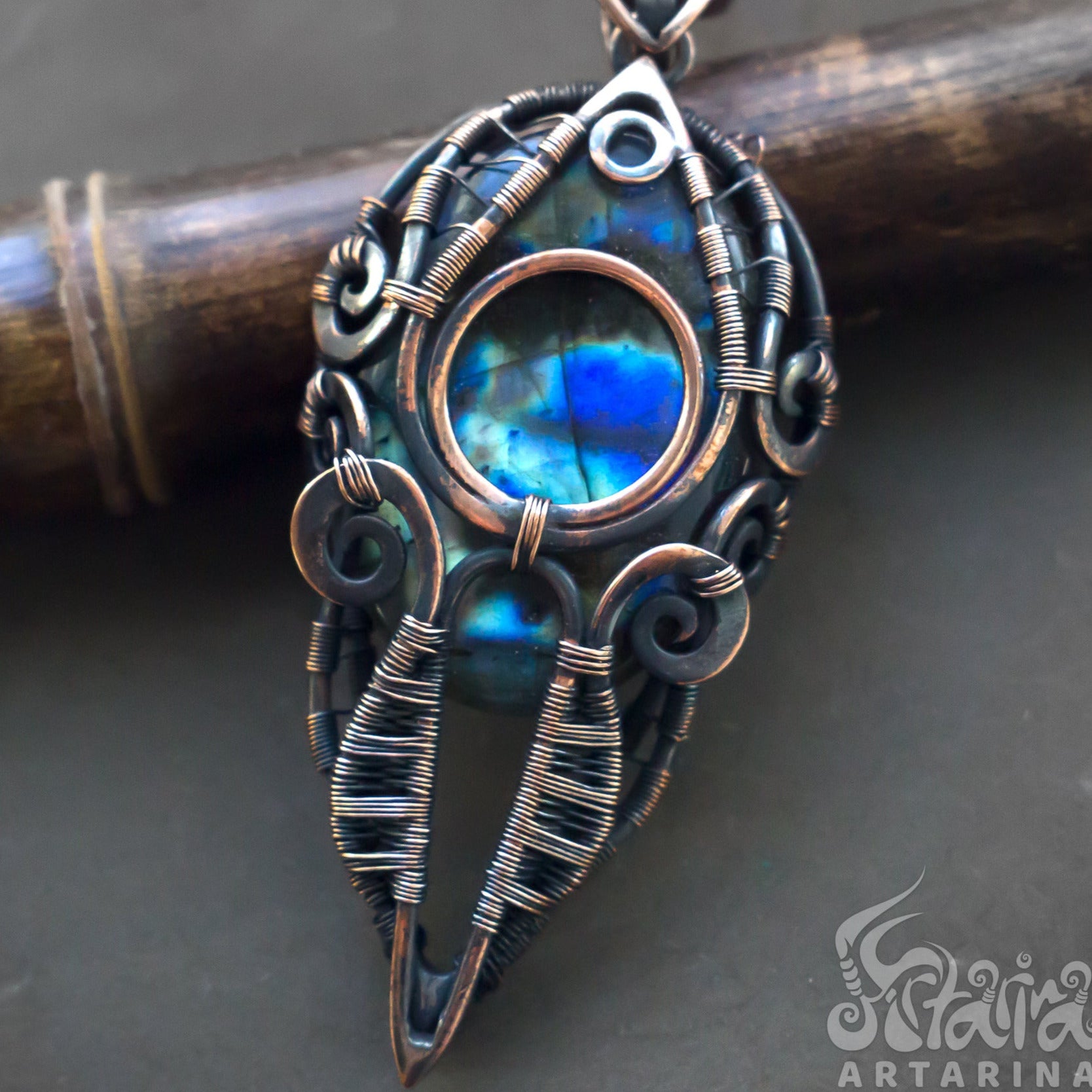 Men's wire wrapped pendant made from copper with multicolored blue spectrolite labradorite