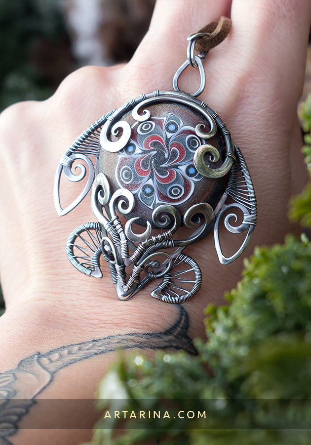 Sterling silver wire wrap turtle necklace with hand blown glass.