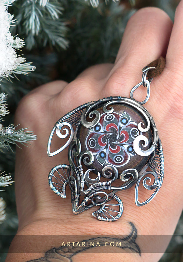 Sterling silver wire wrap turtle necklace with hand blown glass.