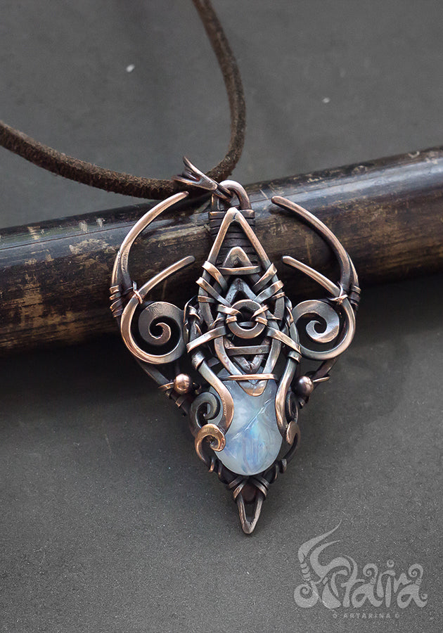 Copper wire wrapped pendant with carved moonstone.