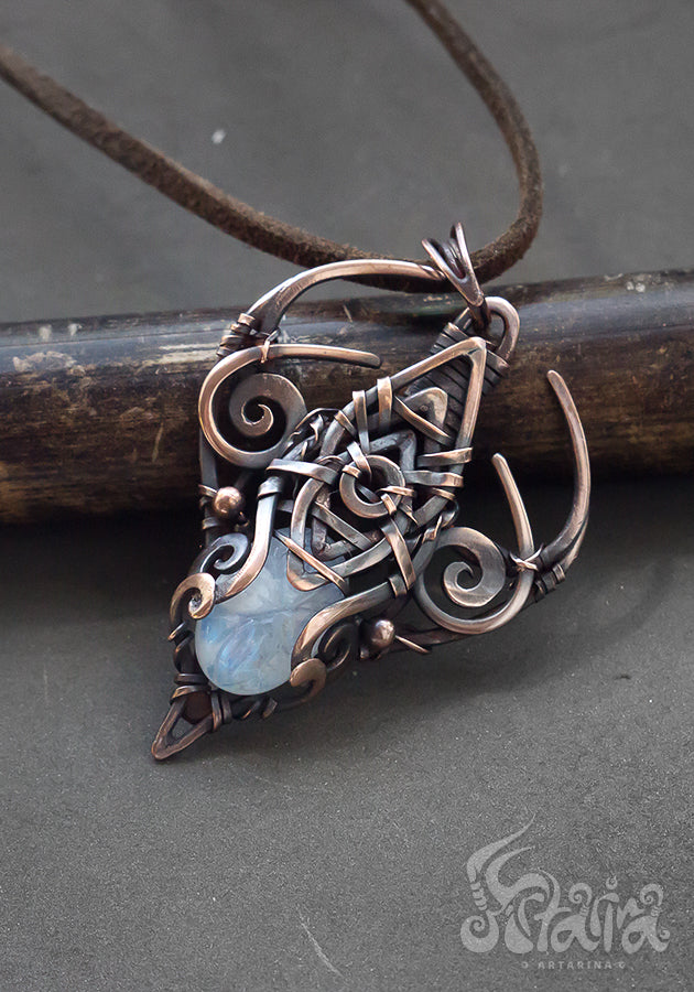 Copper wire wrapped pendant with carved moonstone.