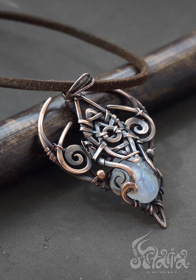 Copper wire wrapped pendant with carved moonstone.