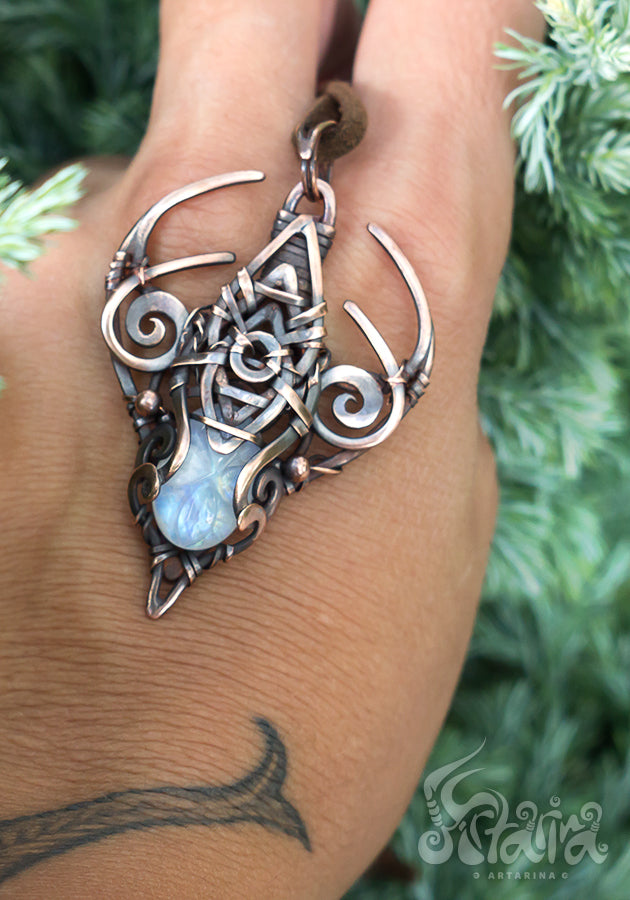 Copper wire wrapped pendant with carved moonstone.
