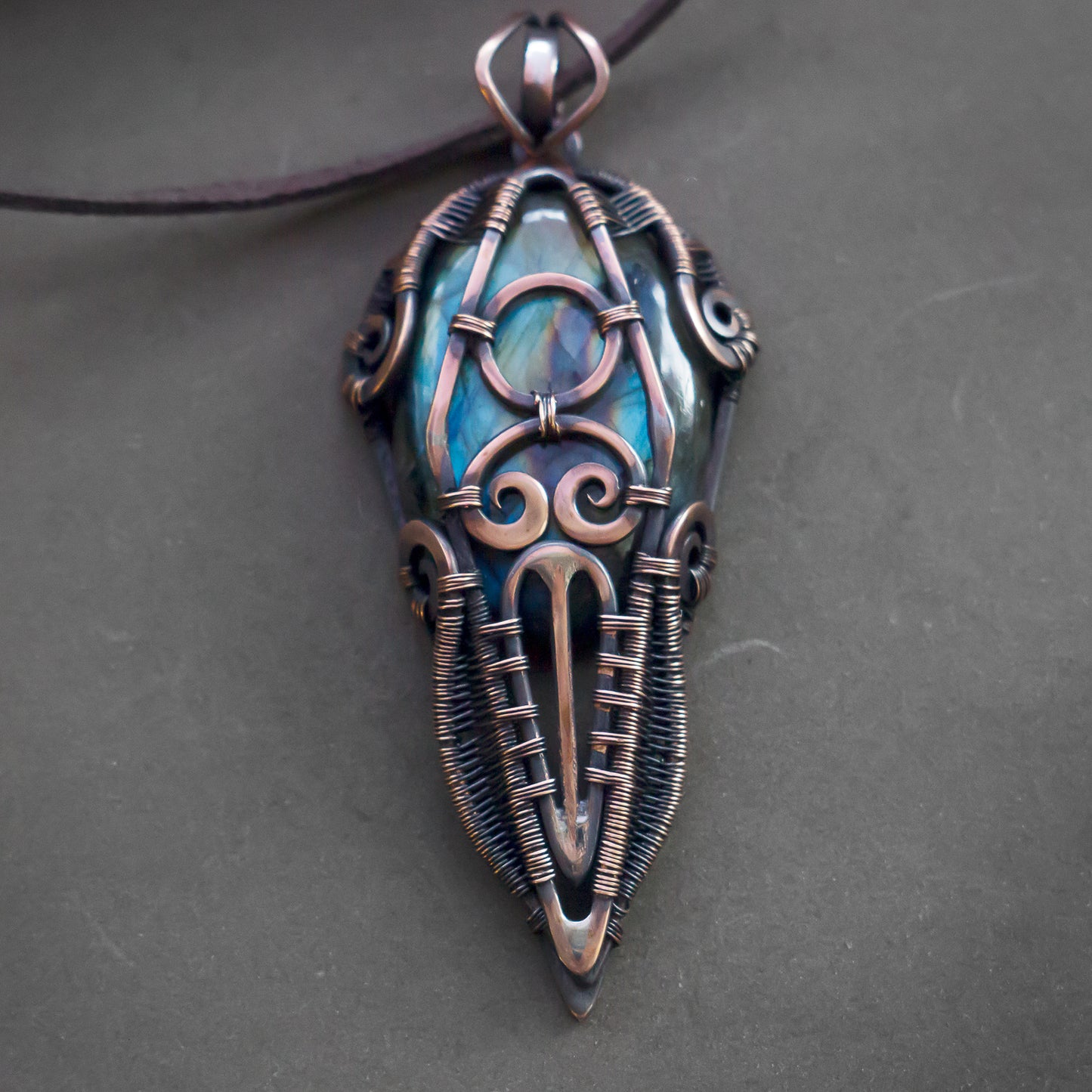 Wire wrapped jewelry for men. Intricate filigree hand weaved pendant with blue and green stone. Dark brown patina freeform necklace