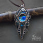 Men's wire wrapped pendant made from copper with multicolored blue spectrolite labradorite