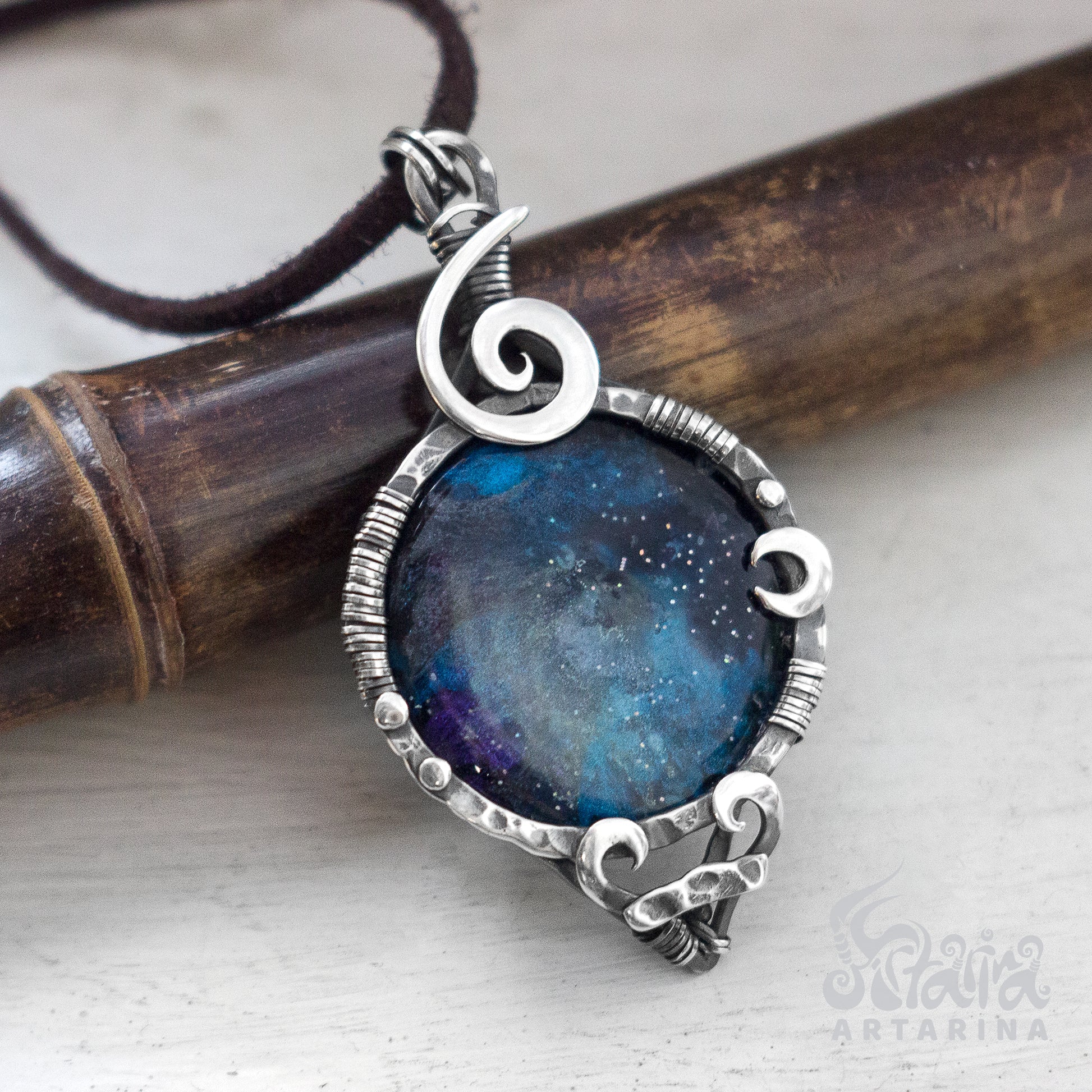 Handmade silver pendant with a cosmic stellar nebula design and a hand-painted night sky epoxy resin cabochon. pic
