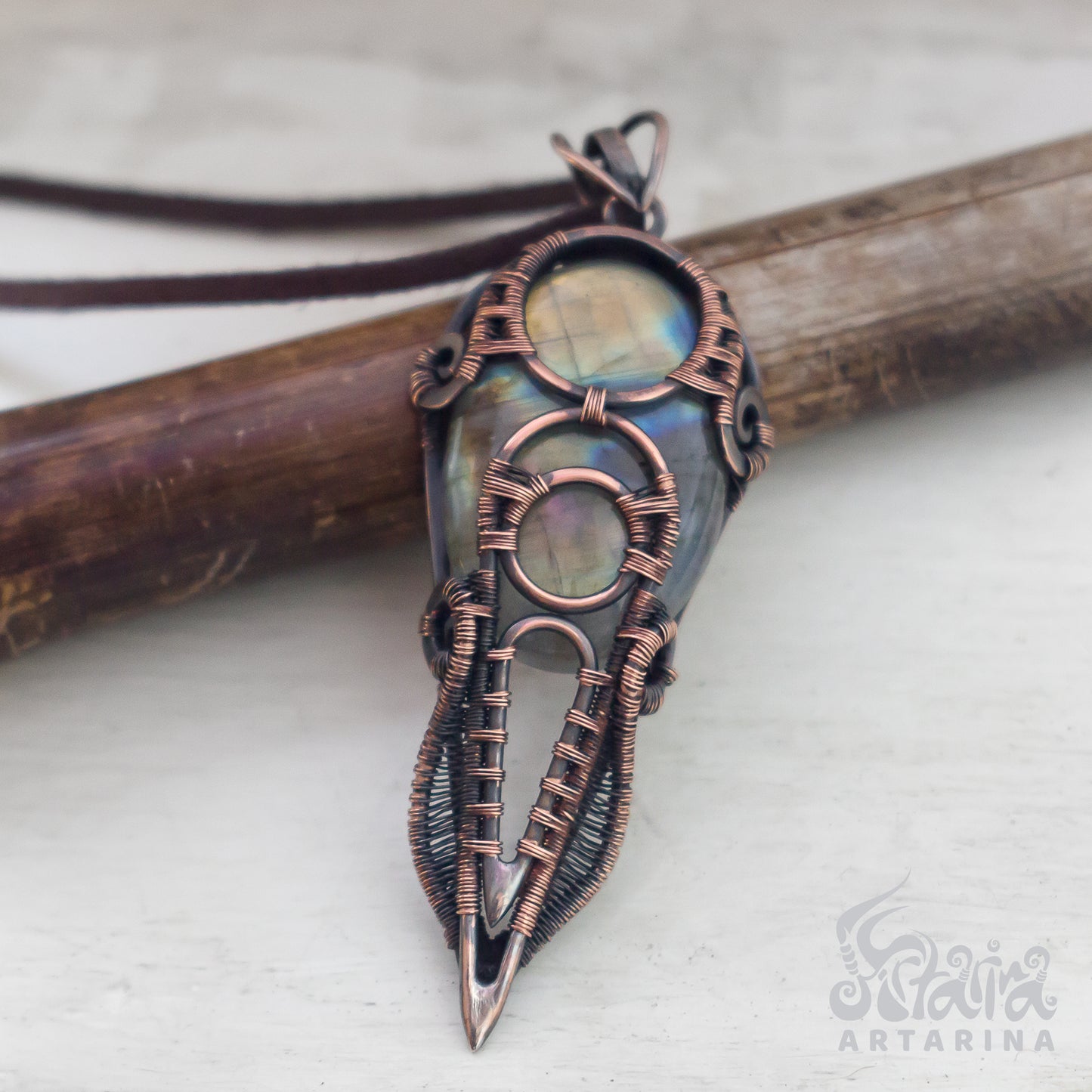 Unique pendant crafted from antiqued copper wire, showcasing a shiny labradorite stone with natural and spiritual allure. pic 2