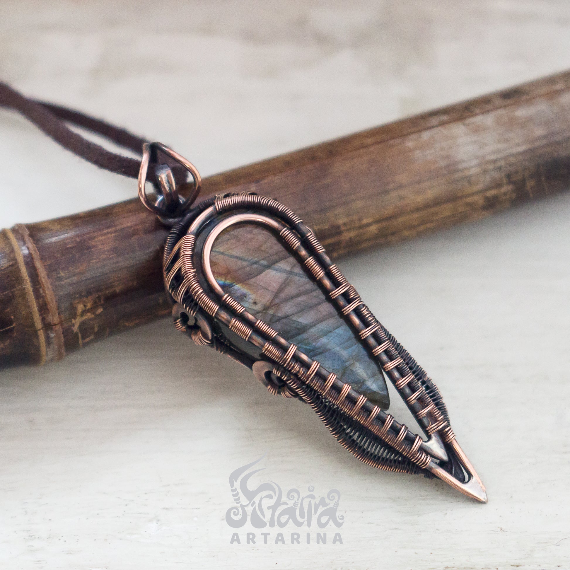 Artisan pendant made from antiqued copper wire, encasing a shiny natural labradorite stone, creating a mystical and one-of-a-kind accessory. pic 1