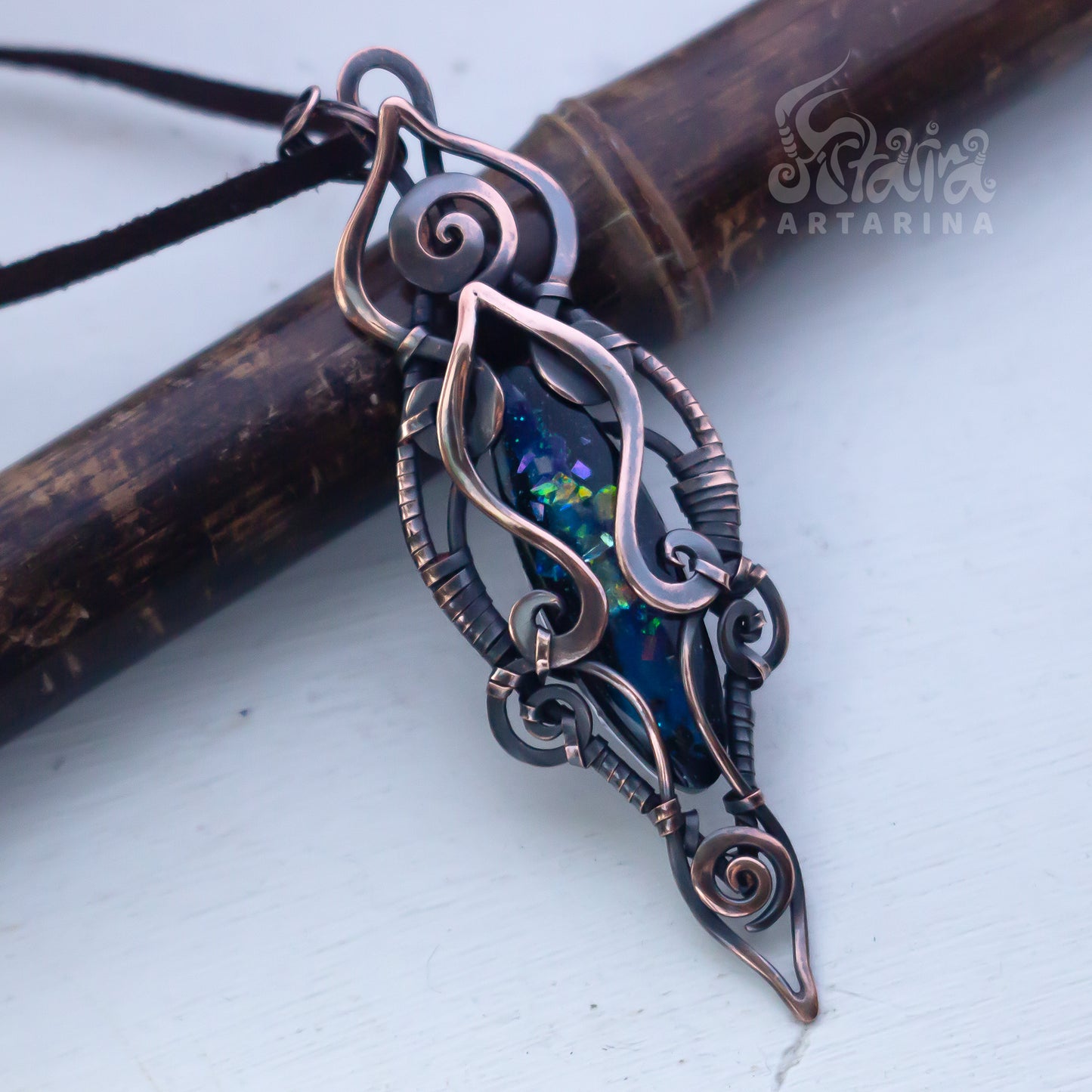 Ornate pendant with intricate design on a white background