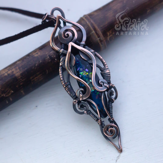 Ornate pendant with intricate design on a white background