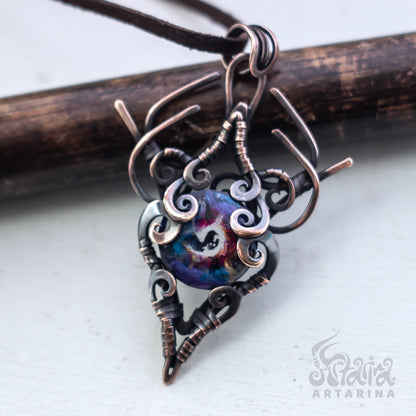 Copper pendant with a heart-shaped design on a white background