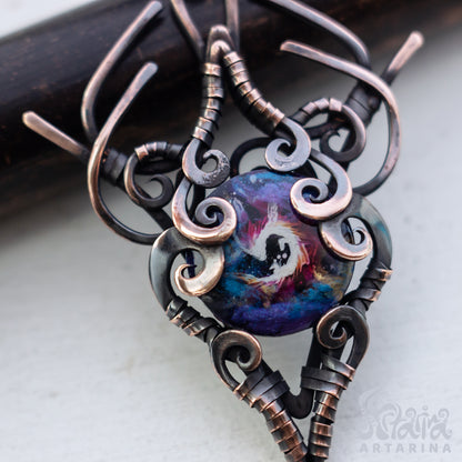 Ornate pendant with a colorful central design on a light background