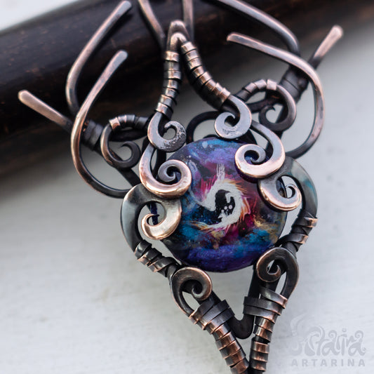 Ornate pendant with a colorful central design on a light background