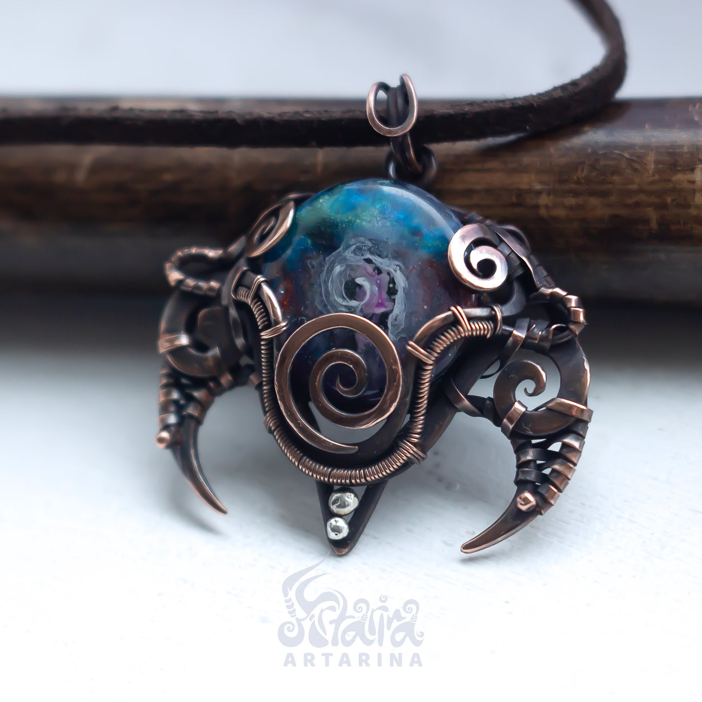 Ornate pendant with intricate designs on a white background