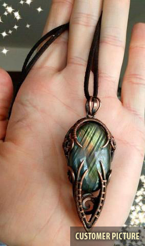 Yellow and green labradorite stone wire wrapped copper necklace in hand