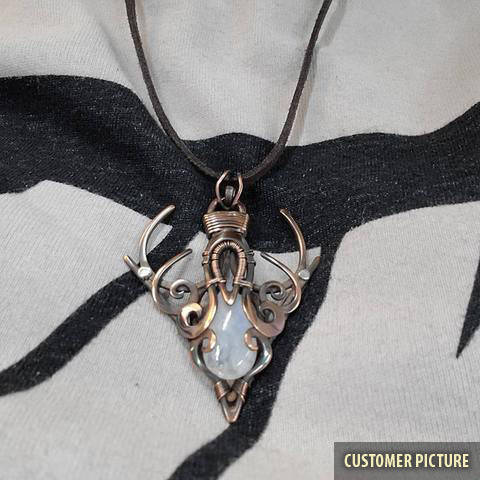 Copper wire wrapped moonstone pendant on chest