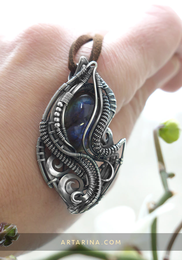Silver wire wrap necklace in hand