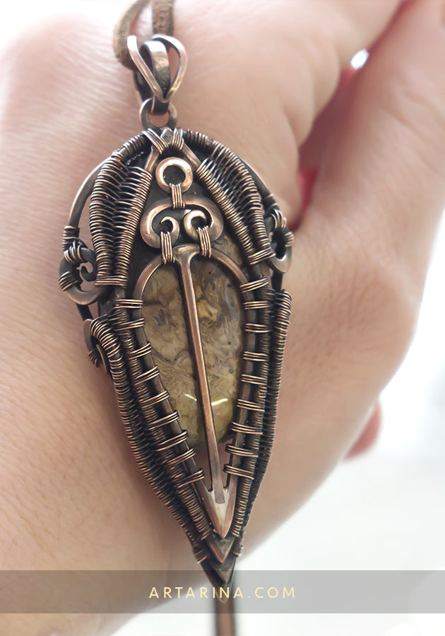 Wire wrap necklace in hand