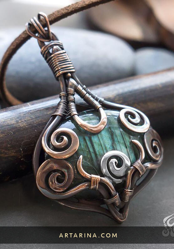 Mysterious amulet wire wrapped necklace made from brown copper, sterling silver and green labradorite.