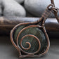 back side Mysterious amulet wire wrapped necklace made from brown copper, sterling silver and green labradorite.